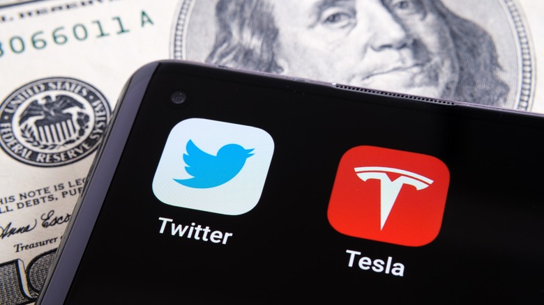 Twitter and Tesla app on smartphone