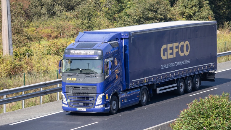 Blue Volvo semi-truck on the road