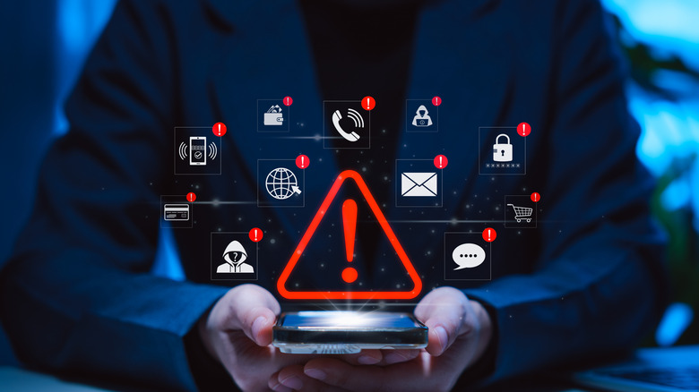 Phone with danger sign graphic above indicating security issues.