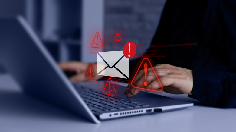 Person using a laptop with a malicious email.