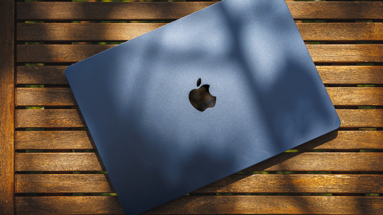 A MacBook Air on a wooden table.