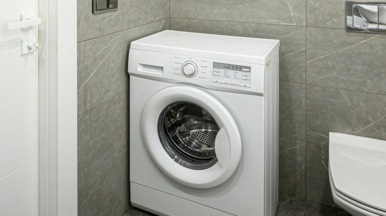 Modern bathroom with a compact washing machine