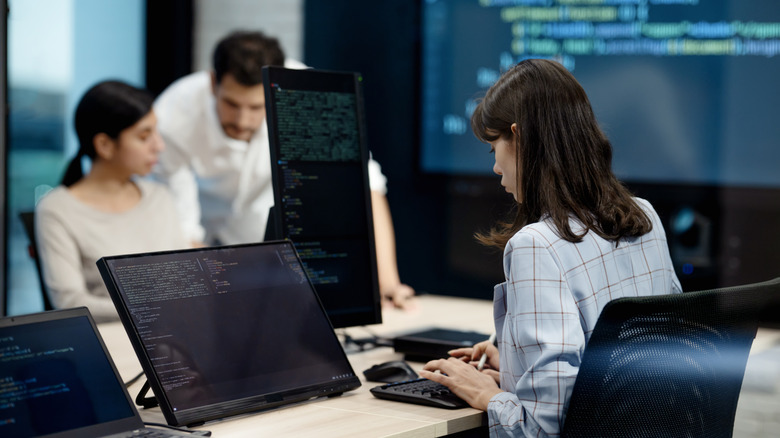 computer programmers, working at a desk