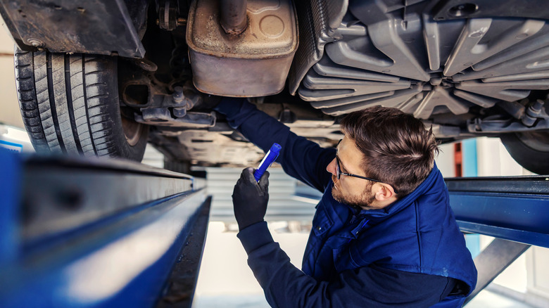 Technician inspects car for hidden issue
