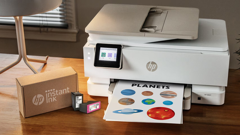 HP printer with ink on a wooden table