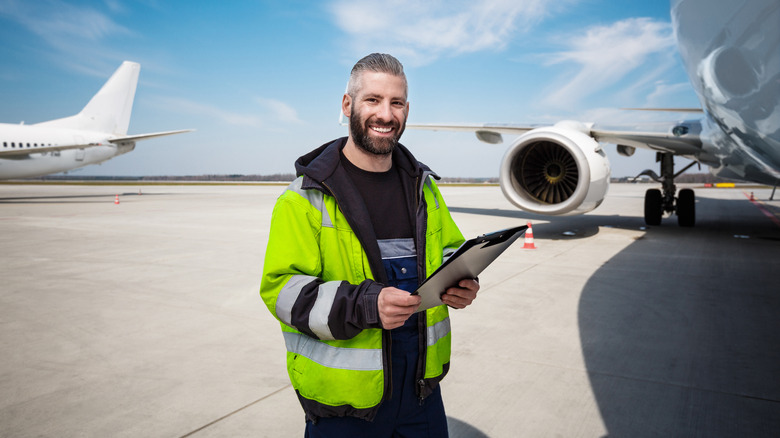 aircraft engineer in front of a plane