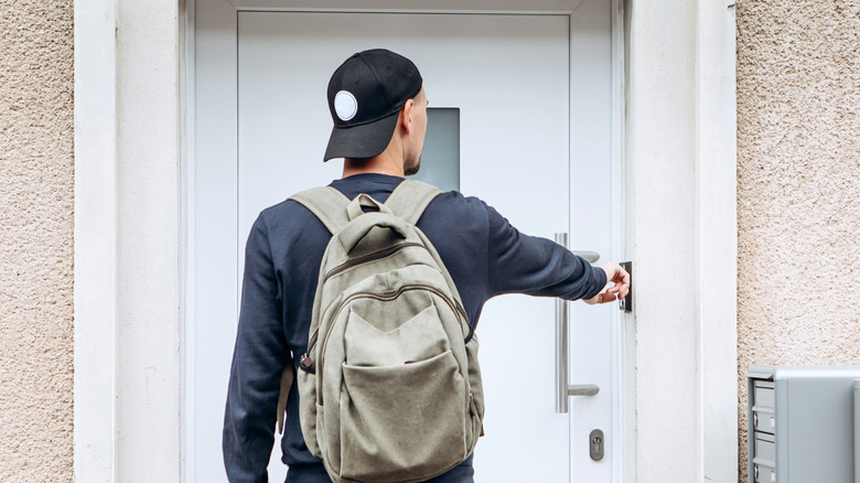 Person using doorbell