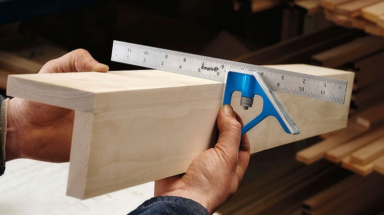 Person shecking the squareness of two jointed boards