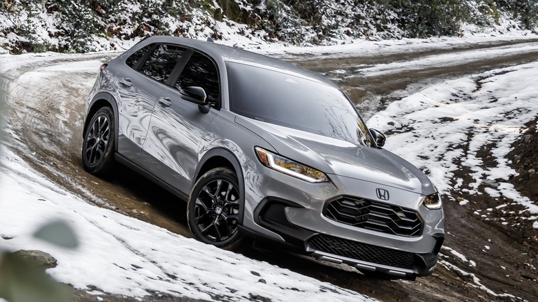 Front 3/4 view of Honda HR-V on snowy, mountainous dirt road