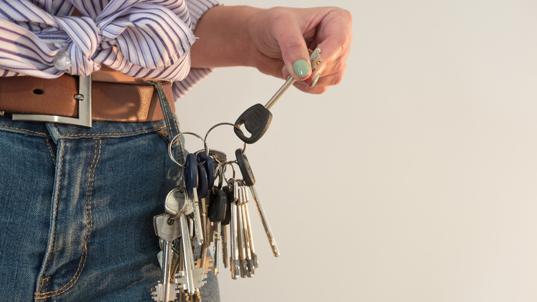 Hand holding a large set of keys