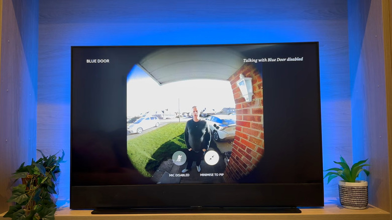 man looking into ring camera on front porch shown on tv set
