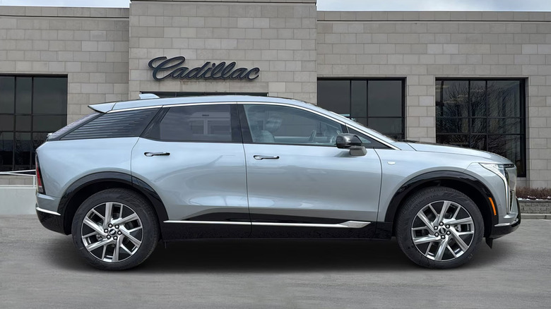 A Nimbus Metallic Cadillac Optiq parked in front of a dealership