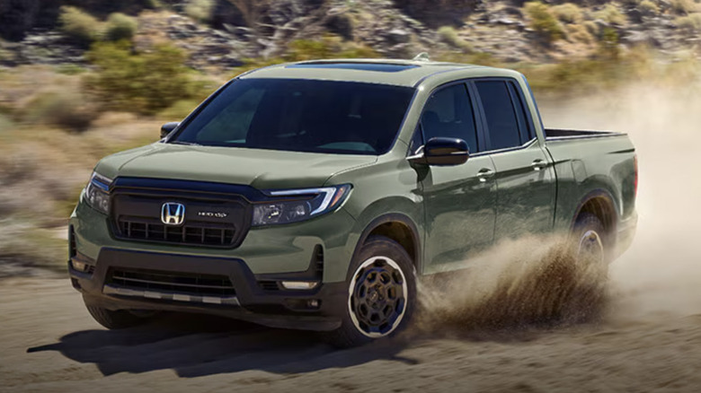 A Honda Ridgeline driving on a dirt road