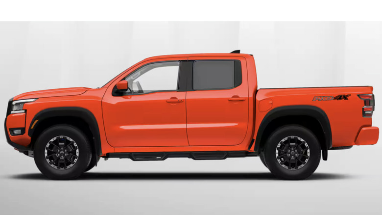 A bright orange Nissan Frontier from the side