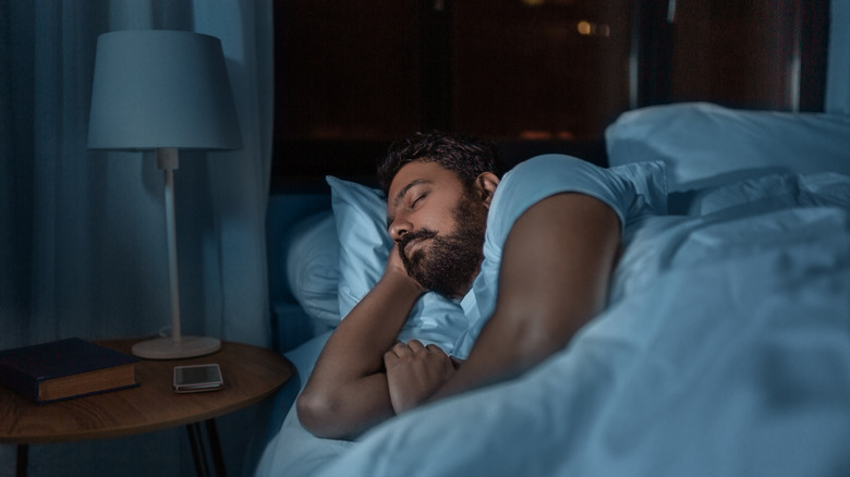 Man asleep in bed