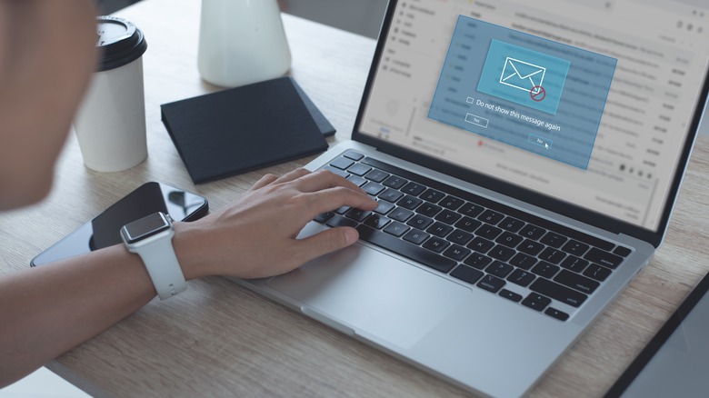 man opening phishing scam email