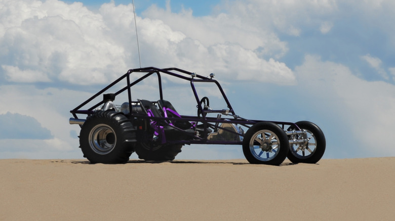 Sand rail dune buggy on sand with blue sky