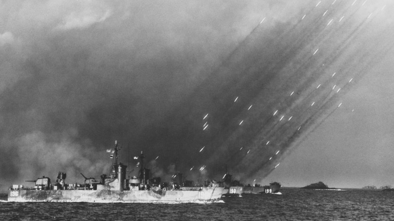 USS LSM(R)-190 (MacKay) fires a barrage of rockets in salvos on to the shores of Tokishi Shima