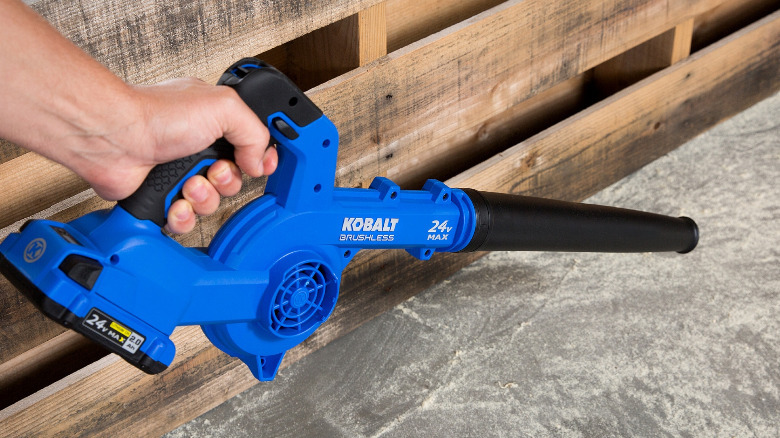 A Kobalt jobsite blower with a thin nozzle in use.