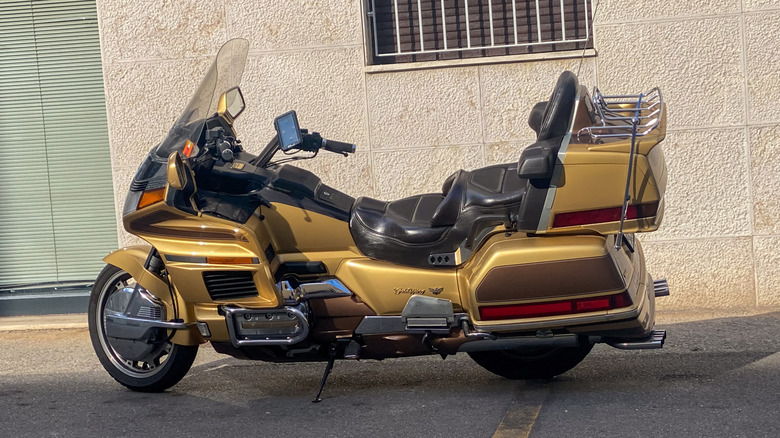 Large touring motorcycle parked near building.