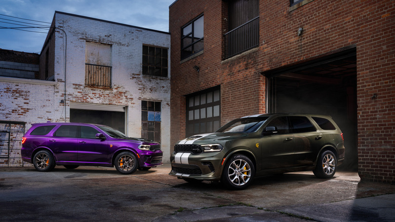 Two 2026 Dodge Durangos parked in driveway in front of brick garage