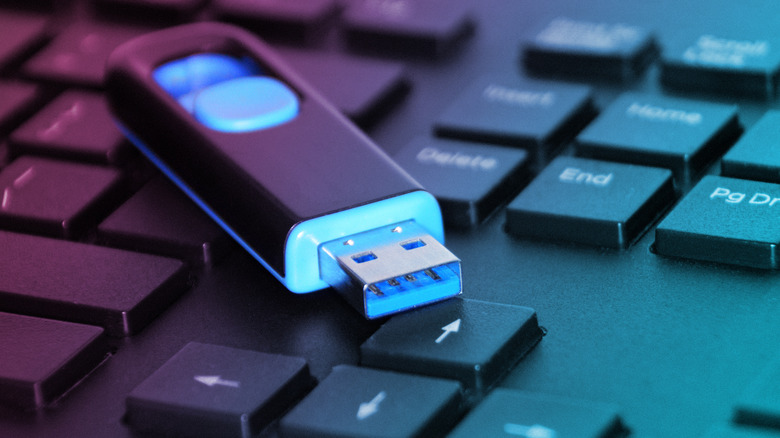 Flash drive sitting on laptop keyboard