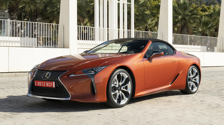 An orange Lexus LC500 convertible parked outside.