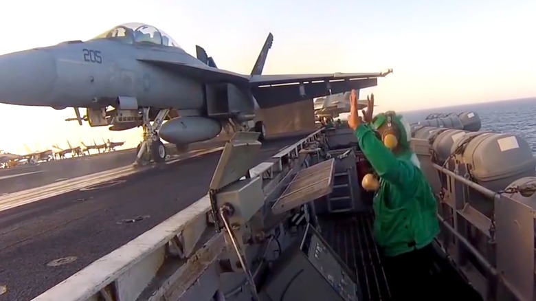 A F/A-18 Hornet taking off from an aircraft carrier