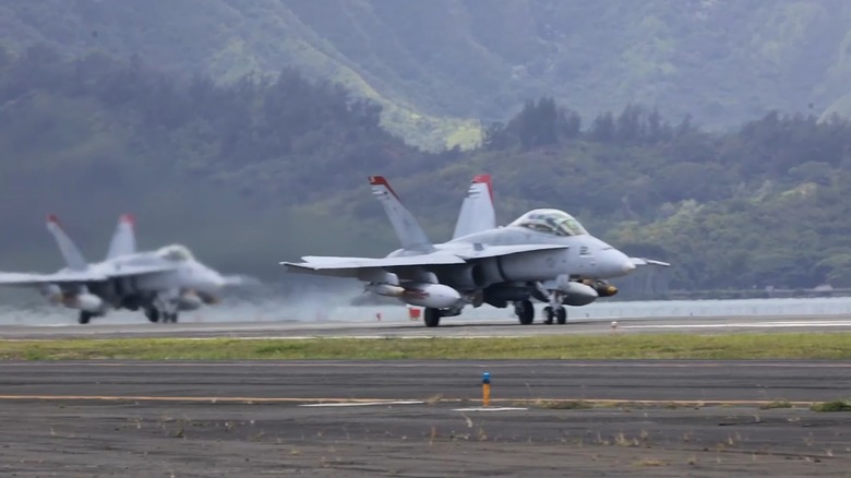 F/A-18's lining up to take off off a runway