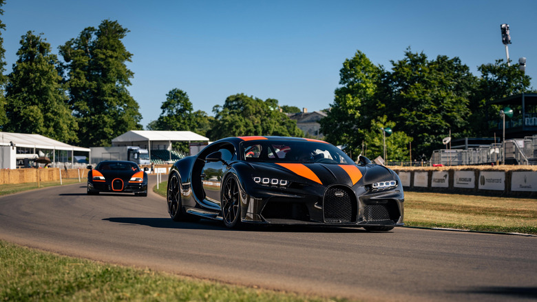 A Bugatti Chiron Super Sport 300+ ahead of Veyron Grand Sport Vitesse on track at Goodwood.