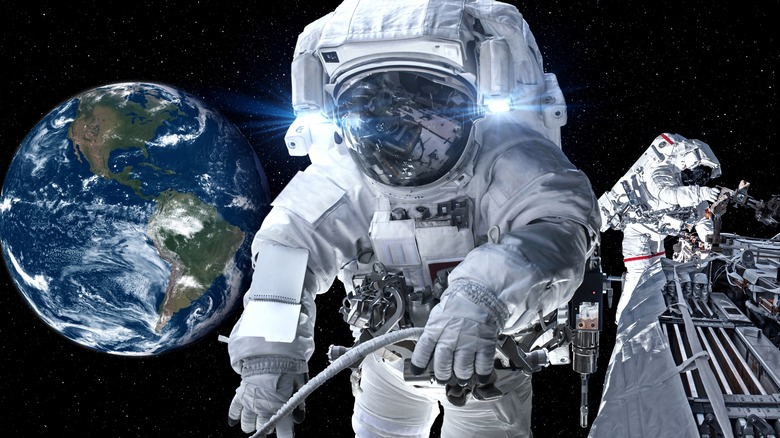 Fully suited astronaut on space walk with Earth in background