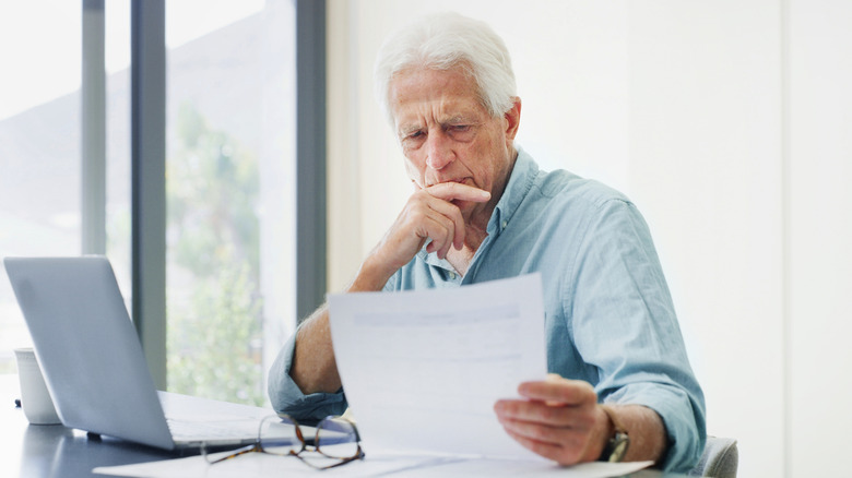 Man looking at bill with concern