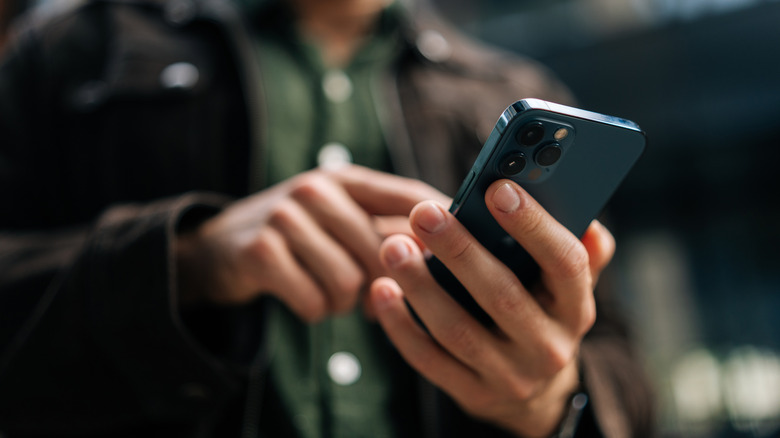A person typing on phone