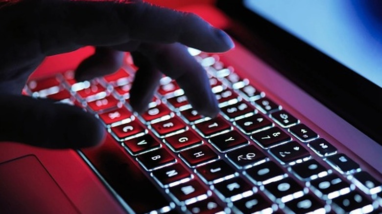 A person using a laptop keyboard to type