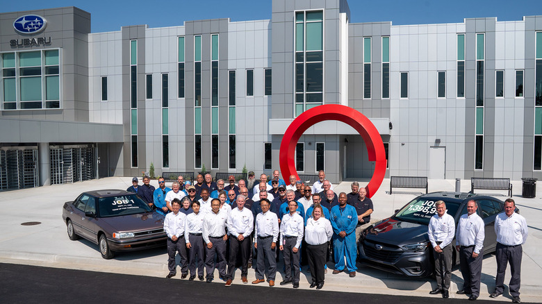 Subaru workers with first and last Subaru Legacy models built in America