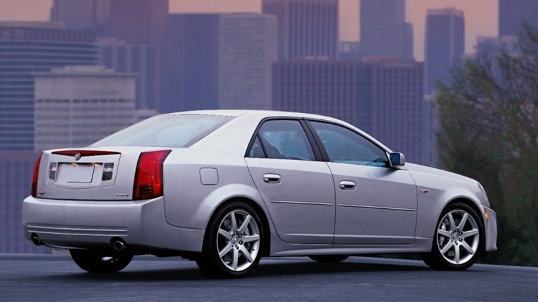 Rear view of silver 2004 Cadillac CTS-V against a city skyline