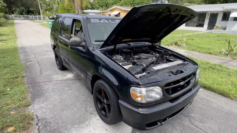 Front 3/4 view of black Saleen Explorer XP8 with hood open.