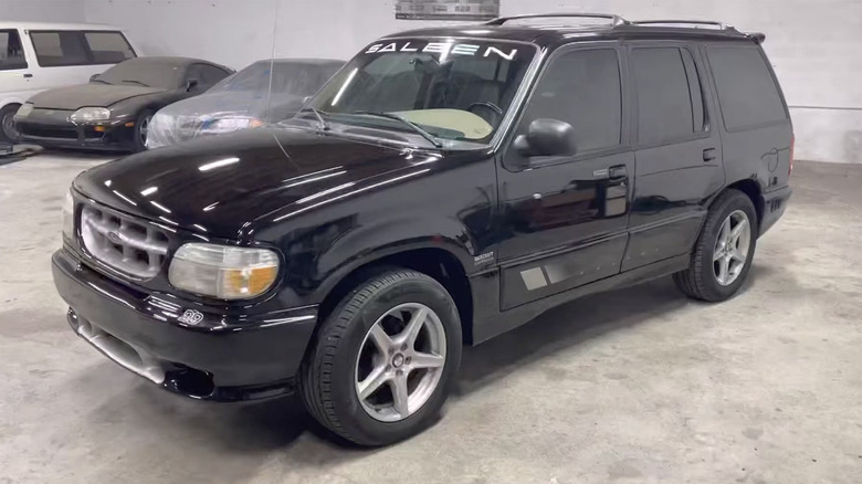 Front 3/4 view of black Saleen Explorer XP8 parked in shop.
