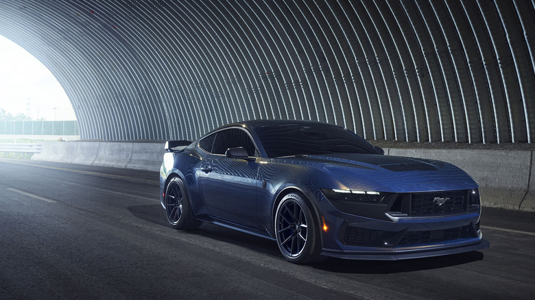 Front 3/4 view of blue Ford Mustang Dark Horse in tunnel.