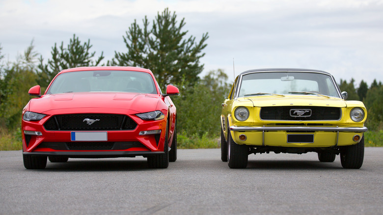 old and new Mustangs parked together