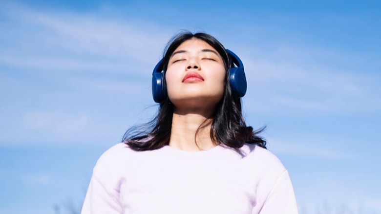 Woman listening to headphones