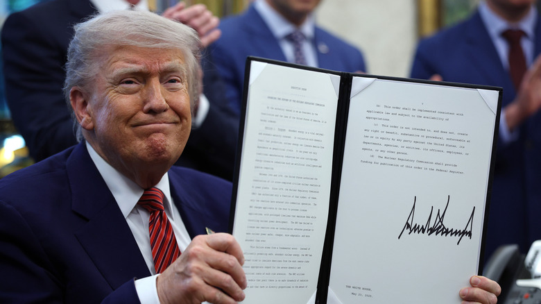 President Trump holding the executive order about SMR funding