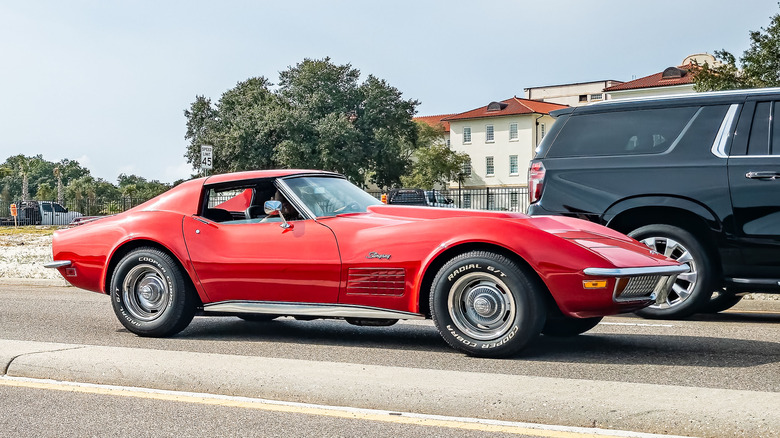 A 1970 Corvette Stingray finished in red, parked on asphalt