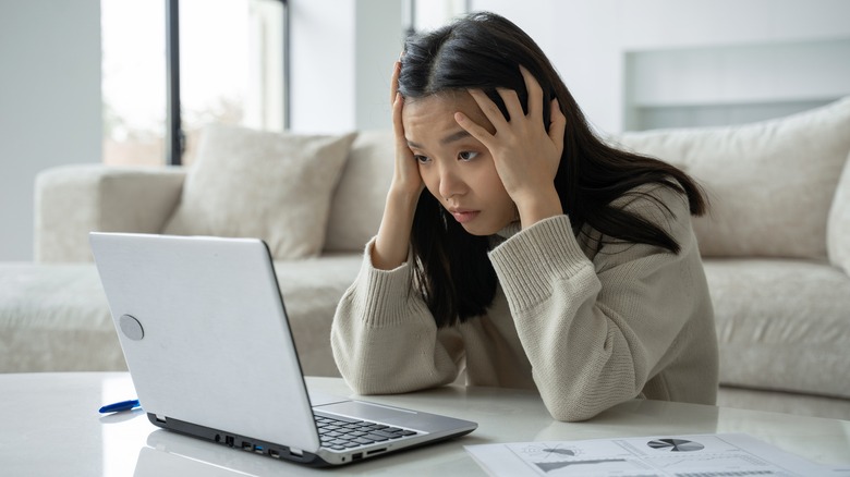 tired person staring at laptop