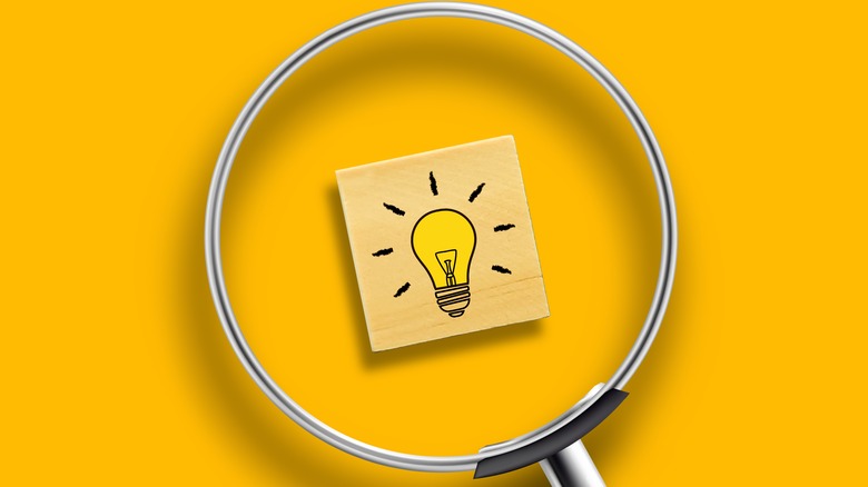 Magnifying glass over lightbulb picture