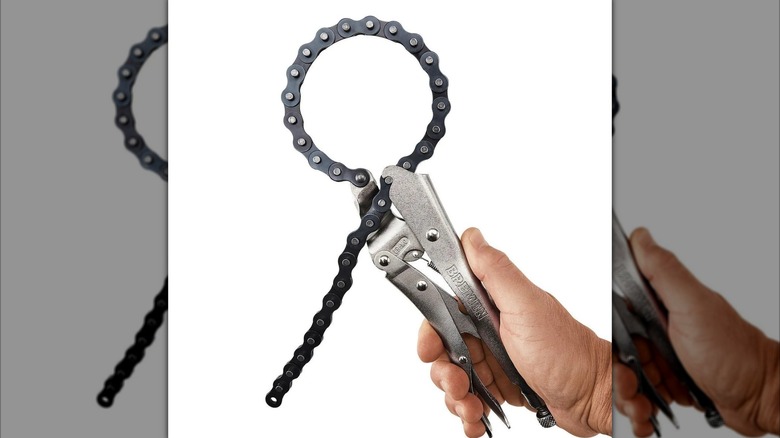 A person holding a Bremen locking chain clamp from Harbor Freight