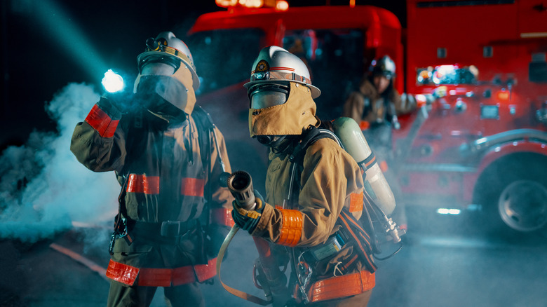 two firefighters near a fire truck