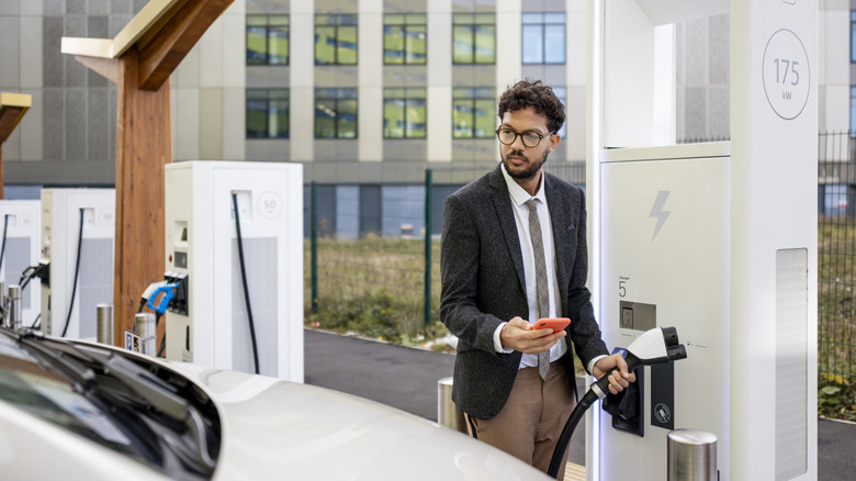 man charging his electric vehicle