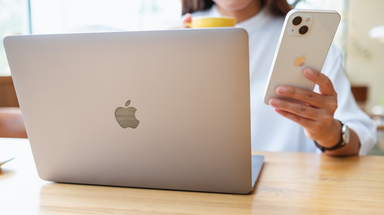 woman with macbook and iphone
