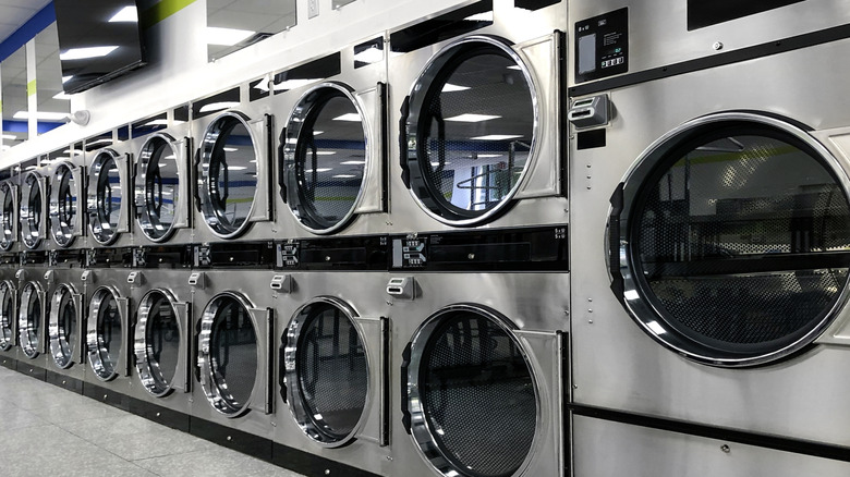 wall of clothes dryers in a laundromat